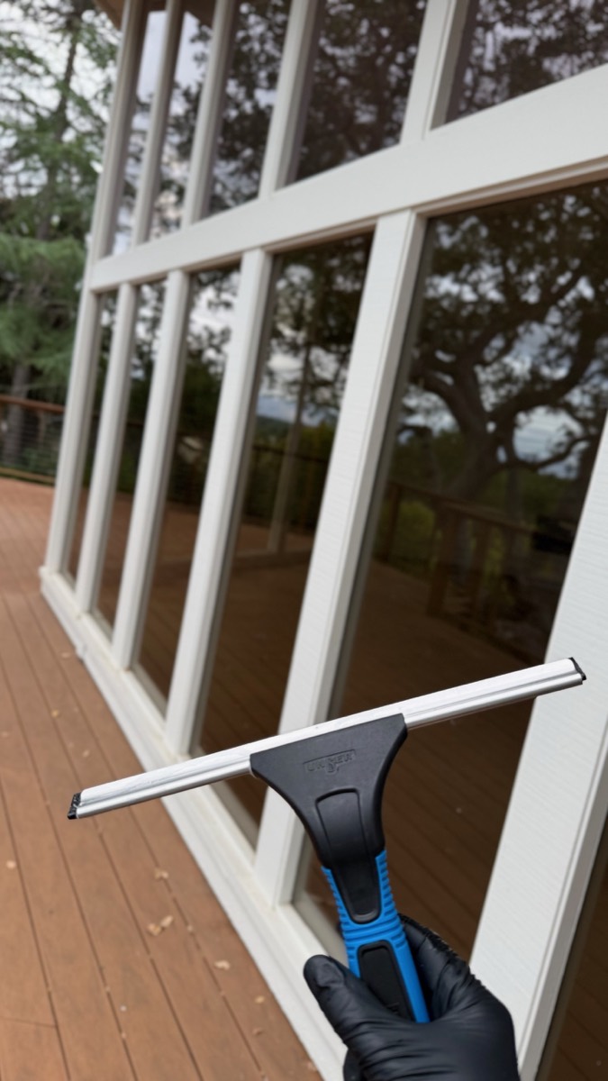Professional exterior window cleaning with a squeegee